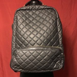 Nila Anthony quilted backpack with gold hardware.
